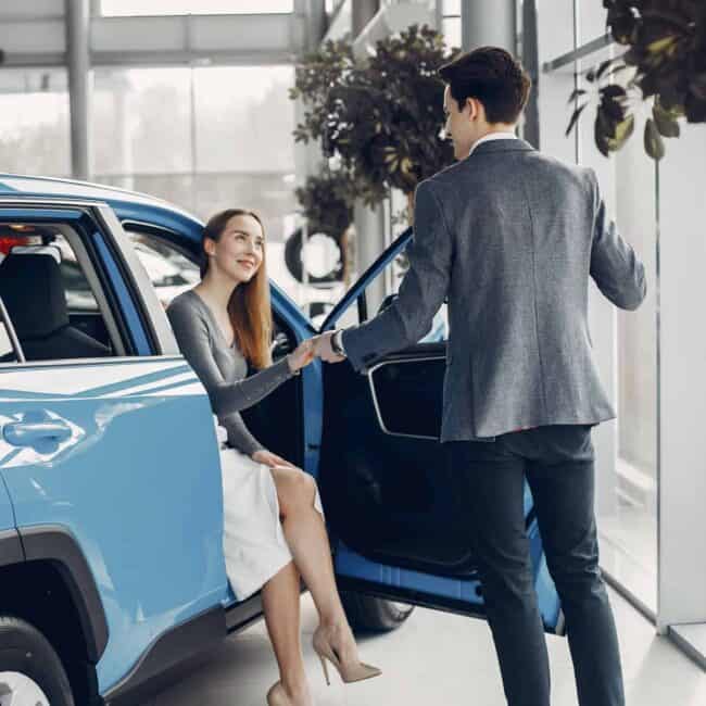 Elegant couple in a car salon