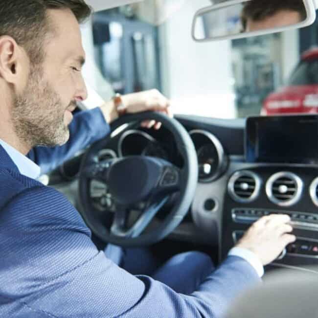 Handsome customer checking the car interior