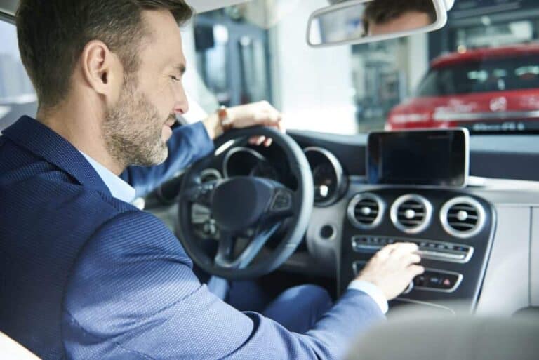 Handsome customer checking the car interior