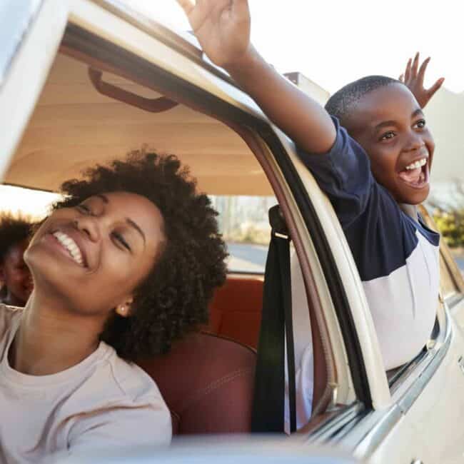 Mother And Children Relaxing In Car During Road Trip