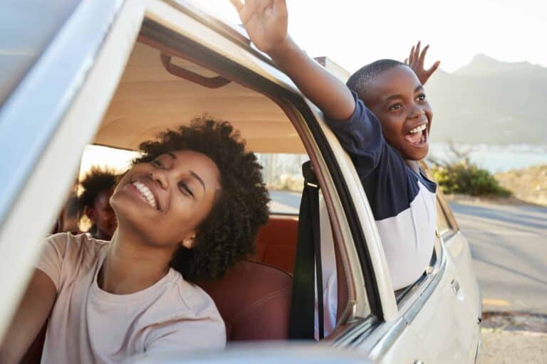 Mother And Children Relaxing In Car During Road Trip